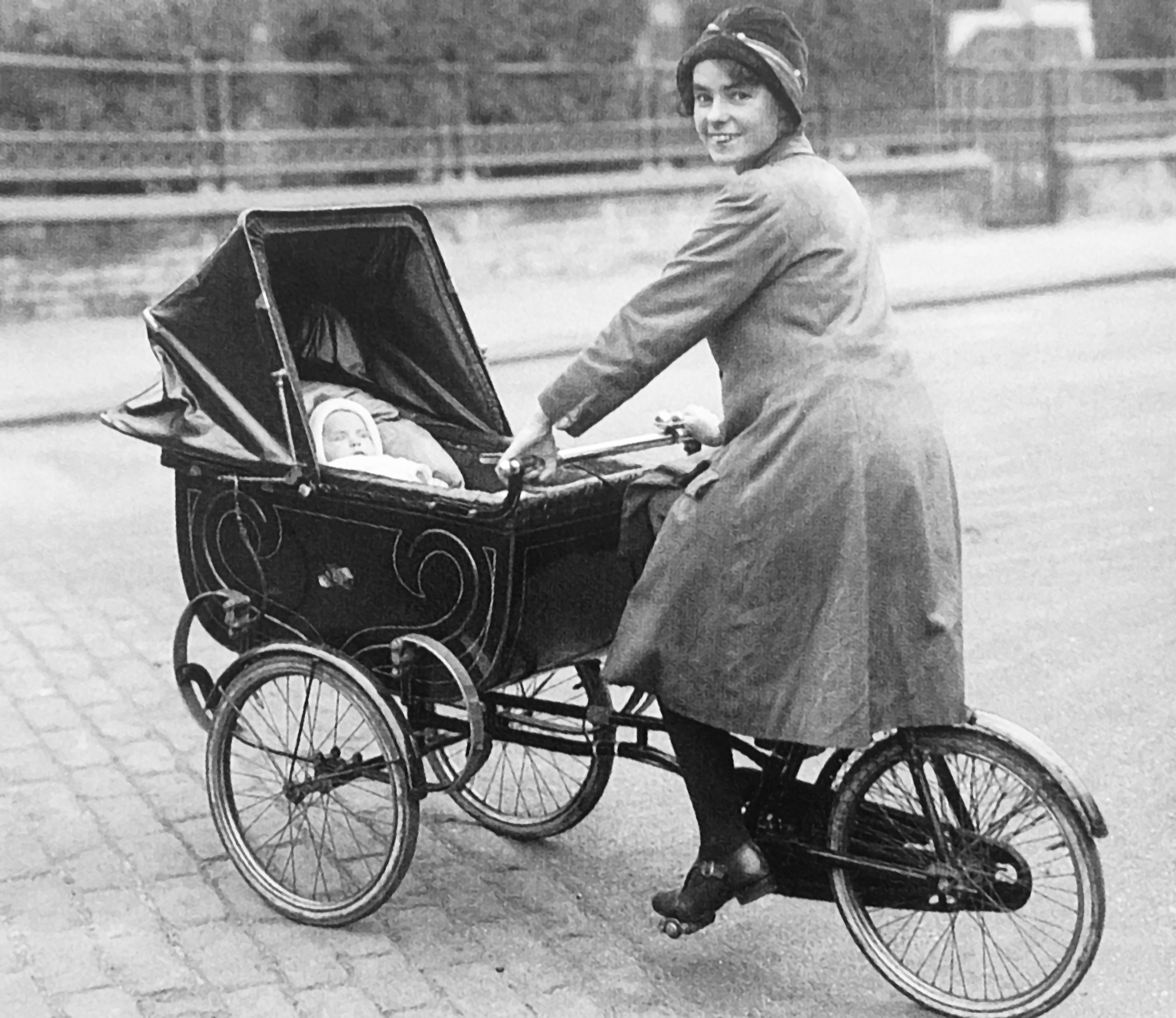 alte Aufnahme (evtl. aus dem Jahr 1940): Frau mit Fahrrad-Kinderwagen-Kombination